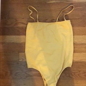 Selling yellow ribbed style body suit